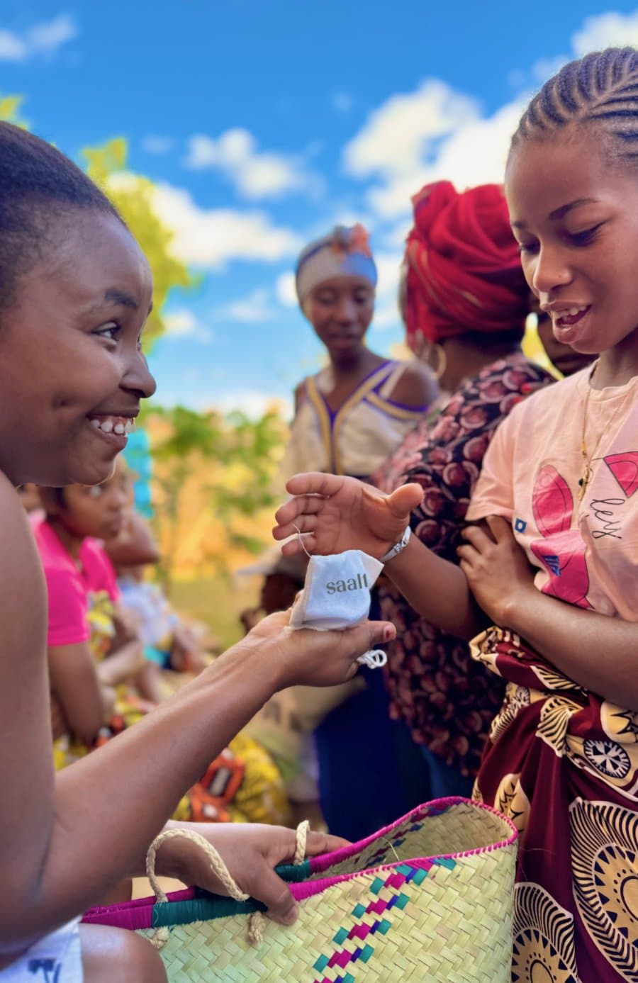 Girls receiving period care products at a community distribution